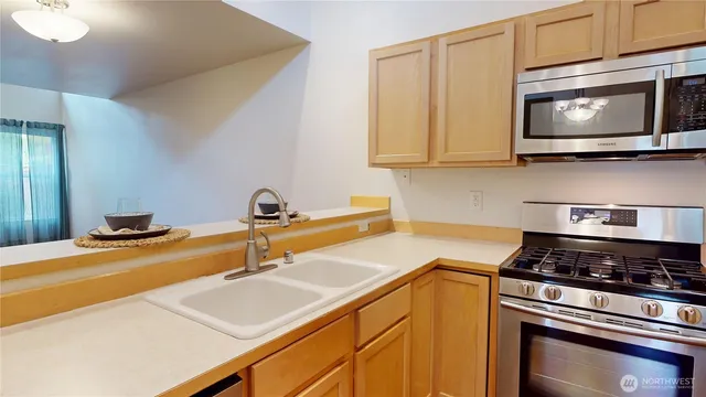 a kitchen with stainless steel appliances granite countertop a refrigerator and a stove