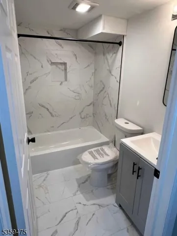 a bathroom with a toilet sink and shower