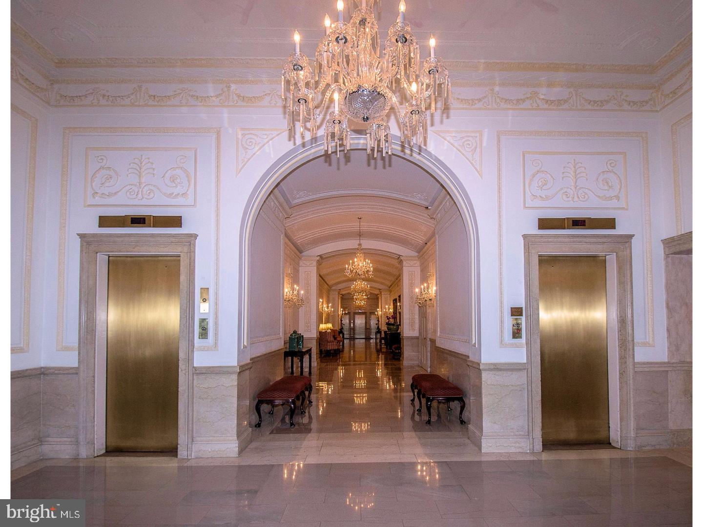 a view of a hallway with chandelier