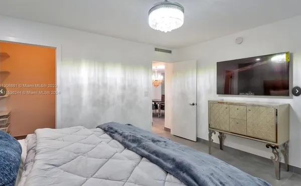 a view of a livingroom with wooden floor and a flat screen tv