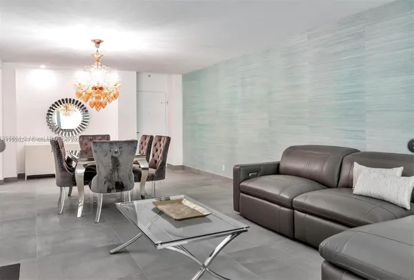 a living room with furniture a rug and a chandelier