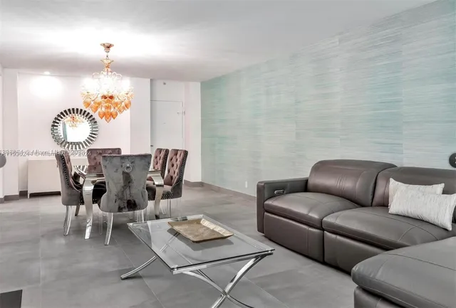 a living room with furniture a rug and a chandelier