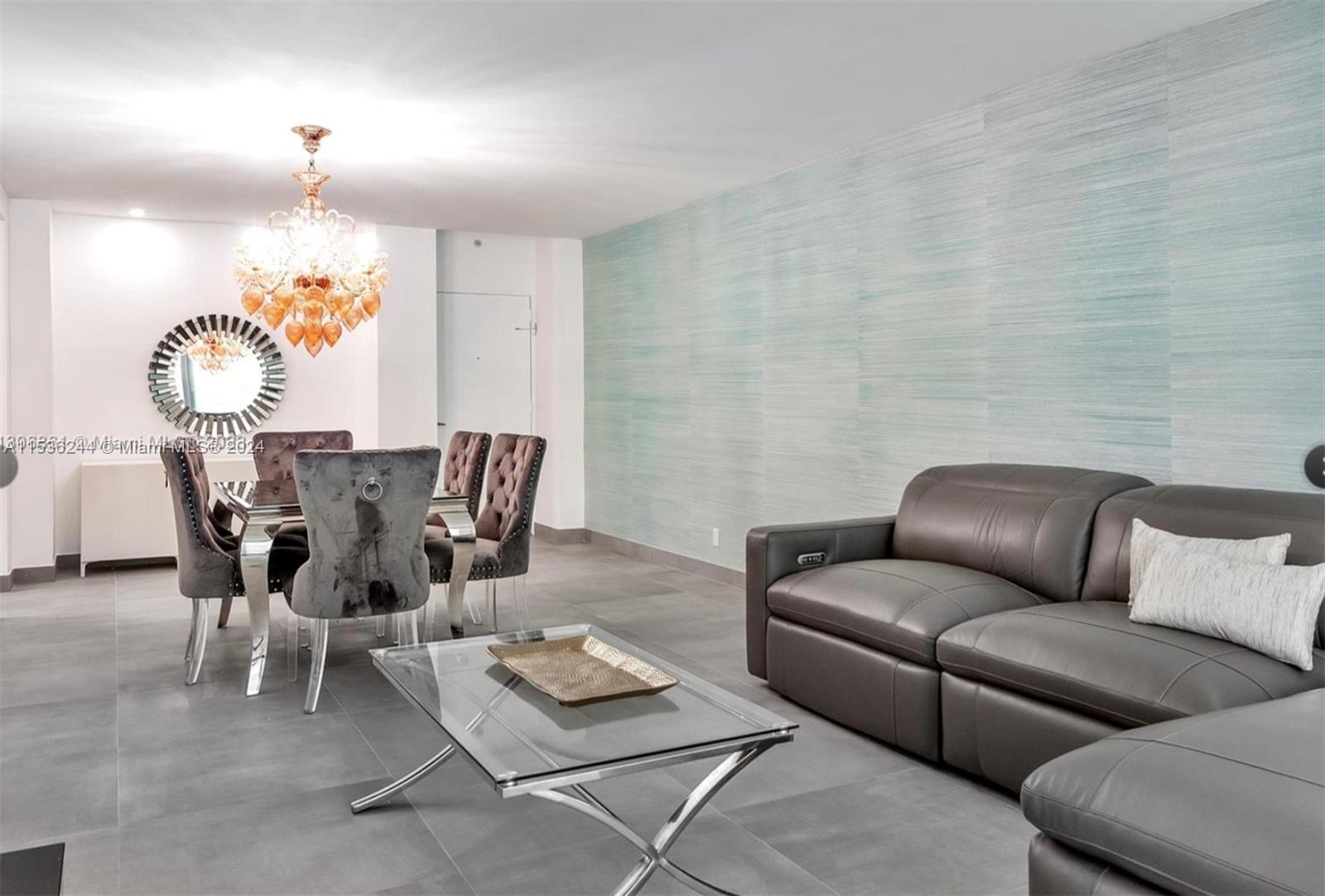 4001 South Ocean Drive, Unit 9F Hollywood, FL 33019 - Photo 14 of 25 a living room with furniture a rug and a chandelier