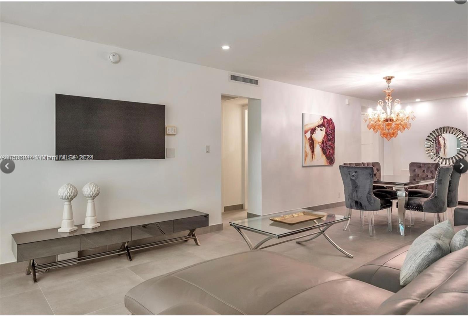 4001 South Ocean Drive, Unit 9F Hollywood, FL 33019 - Photo 15 of 25 a living room with furniture and a flat screen tv