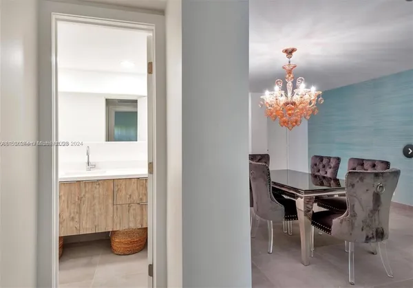 a dining room with furniture and chandelier