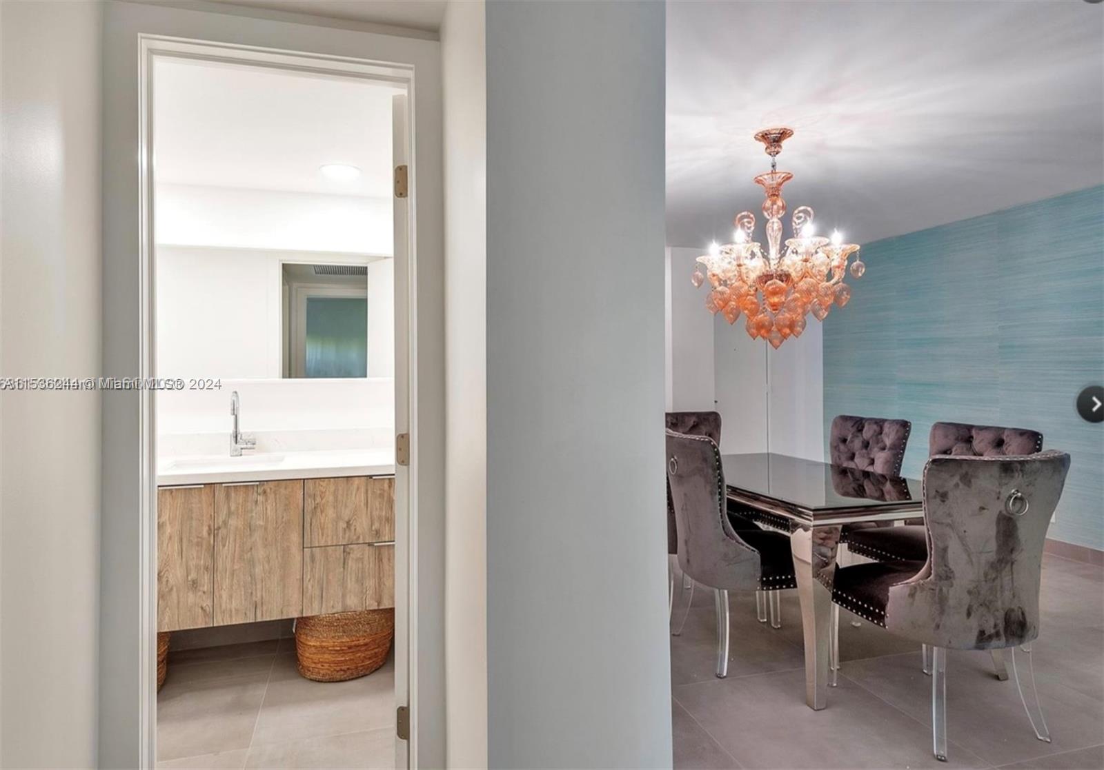 4001 South Ocean Drive, Unit 9F Hollywood, FL 33019 - Photo 16 of 25 a dining room with furniture and chandelier