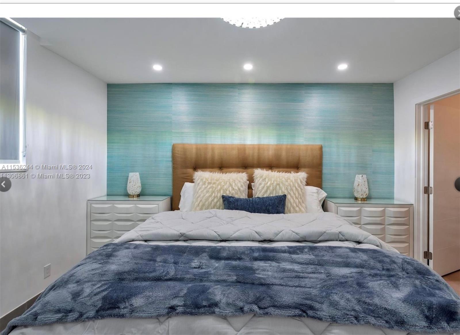 4001 South Ocean Drive, Unit 9F Hollywood, FL 33019 - Photo 19 of 25 a bedroom with a bed and a large mirror