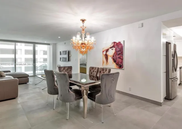a dining room with furniture a livingroom and chandelier