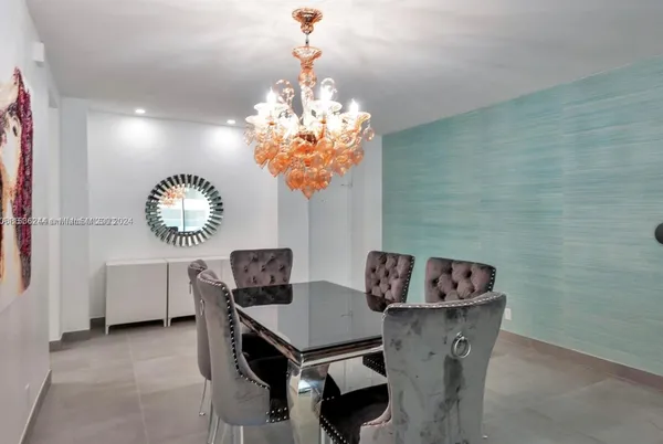 a view of a dining room with furniture and chandelier