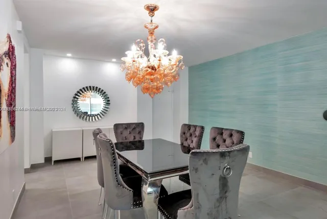 a view of a dining room with furniture and chandelier