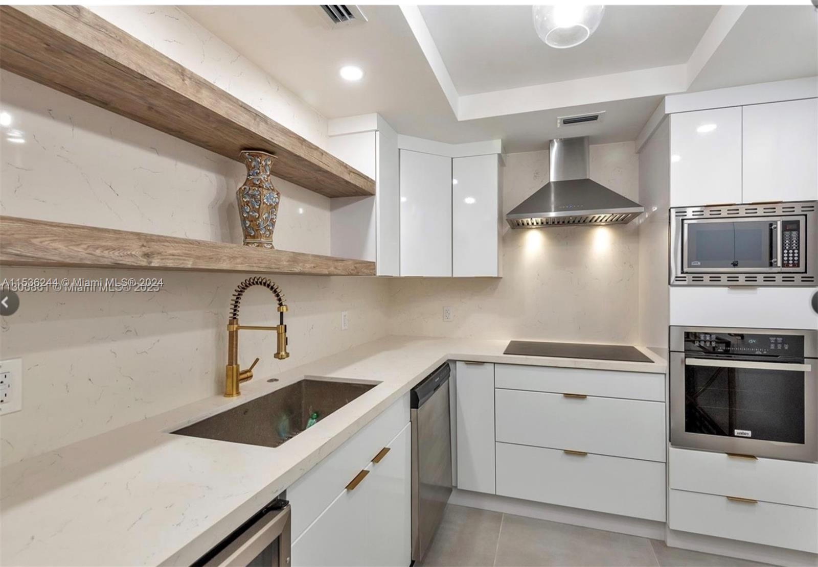 4001 South Ocean Drive, Unit 9F Hollywood, FL 33019 - Photo 6 of 25 a kitchen with a sink a stove and cabinets