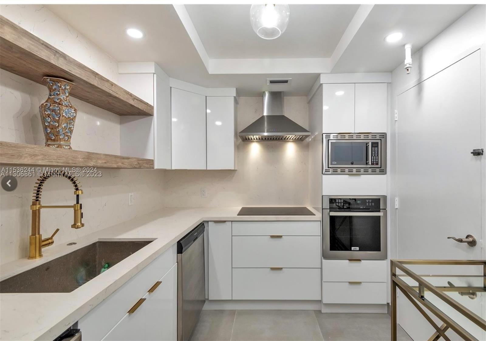 4001 South Ocean Drive, Unit 9F Hollywood, FL 33019 - Photo 7 of 25 a kitchen with a stove sink and refrigerator