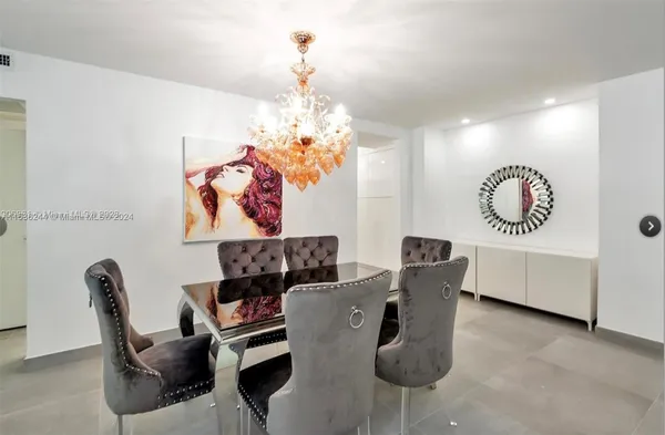 a view of a dining room with furniture and chandelier