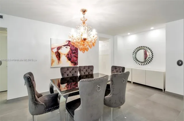 a view of a dining room with furniture and chandelier