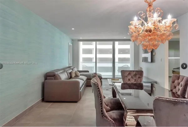 a living room with furniture and a chandelier