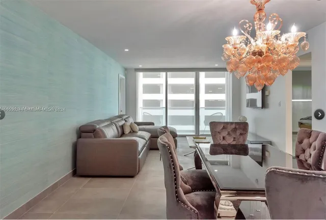 a living room with furniture and a chandelier