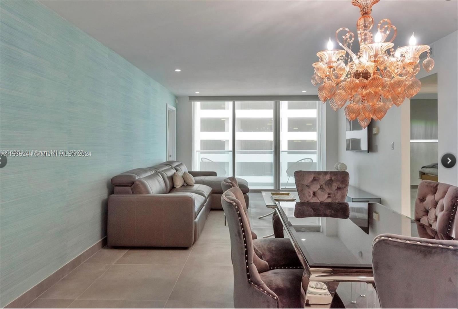4001 South Ocean Drive, Unit 9F Hollywood, FL 33019 - Photo 9 of 25 a living room with furniture and a chandelier