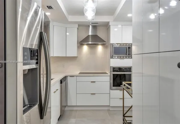 a kitchen with stainless steel appliances a refrigerator and a stove