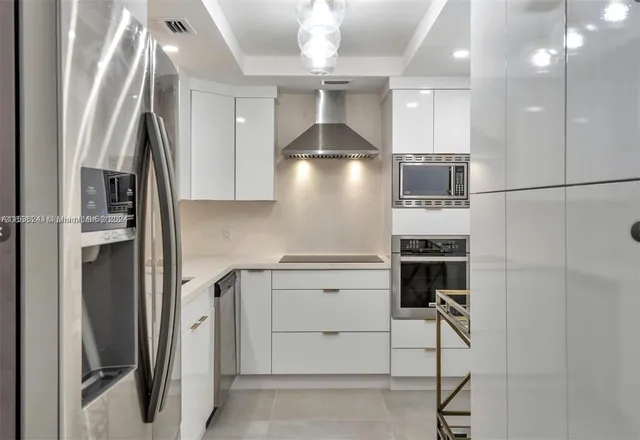 a kitchen with stainless steel appliances a refrigerator and a stove