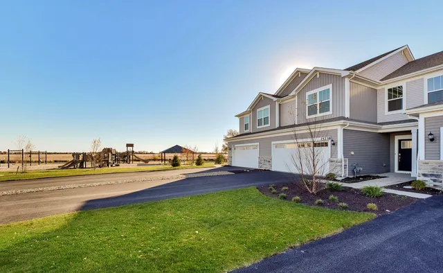 a view of a house with a yard and sitting area