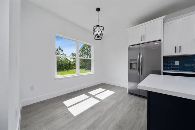 a view of kitchen with furniture window and wooden floor