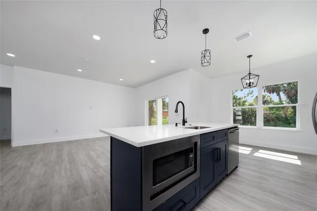 a kitchen with a stove sink and window