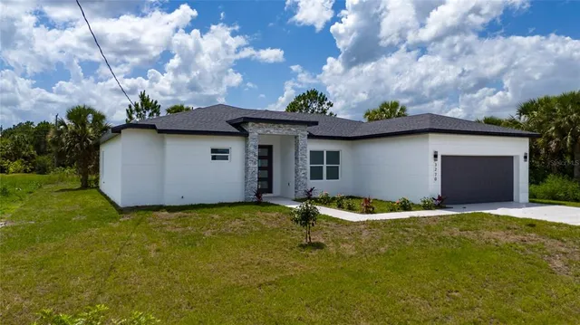 a backyard of a house with yard and garage
