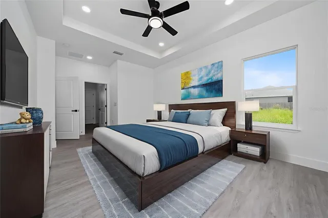 a bedroom with a bed and painting on the wall