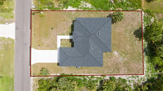 an aerial view of a house with a yard