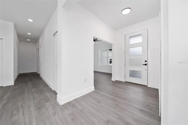 a view of a hallway with wooden floor