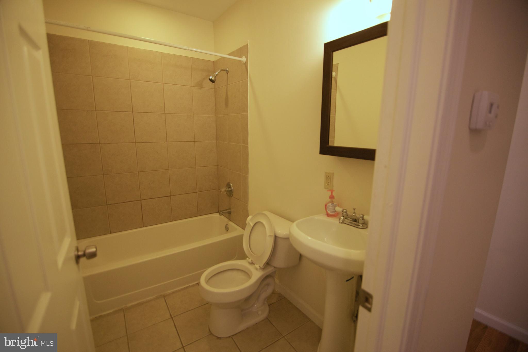1522 North 17th Street, Unit 2 Philadelphia, PA 19121 - Photo 5 of 10 a bathroom with a sink a toilet and shower