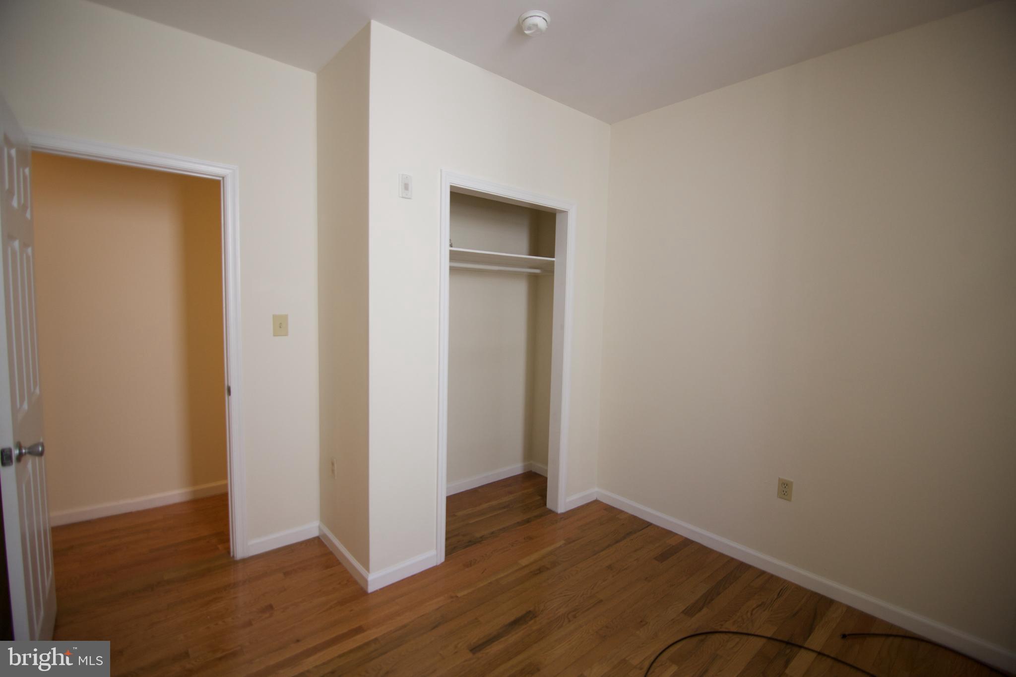1522 North 17th Street, Unit 2 Philadelphia, PA 19121 - Photo 6 of 10 an empty room with wooden floor and closet