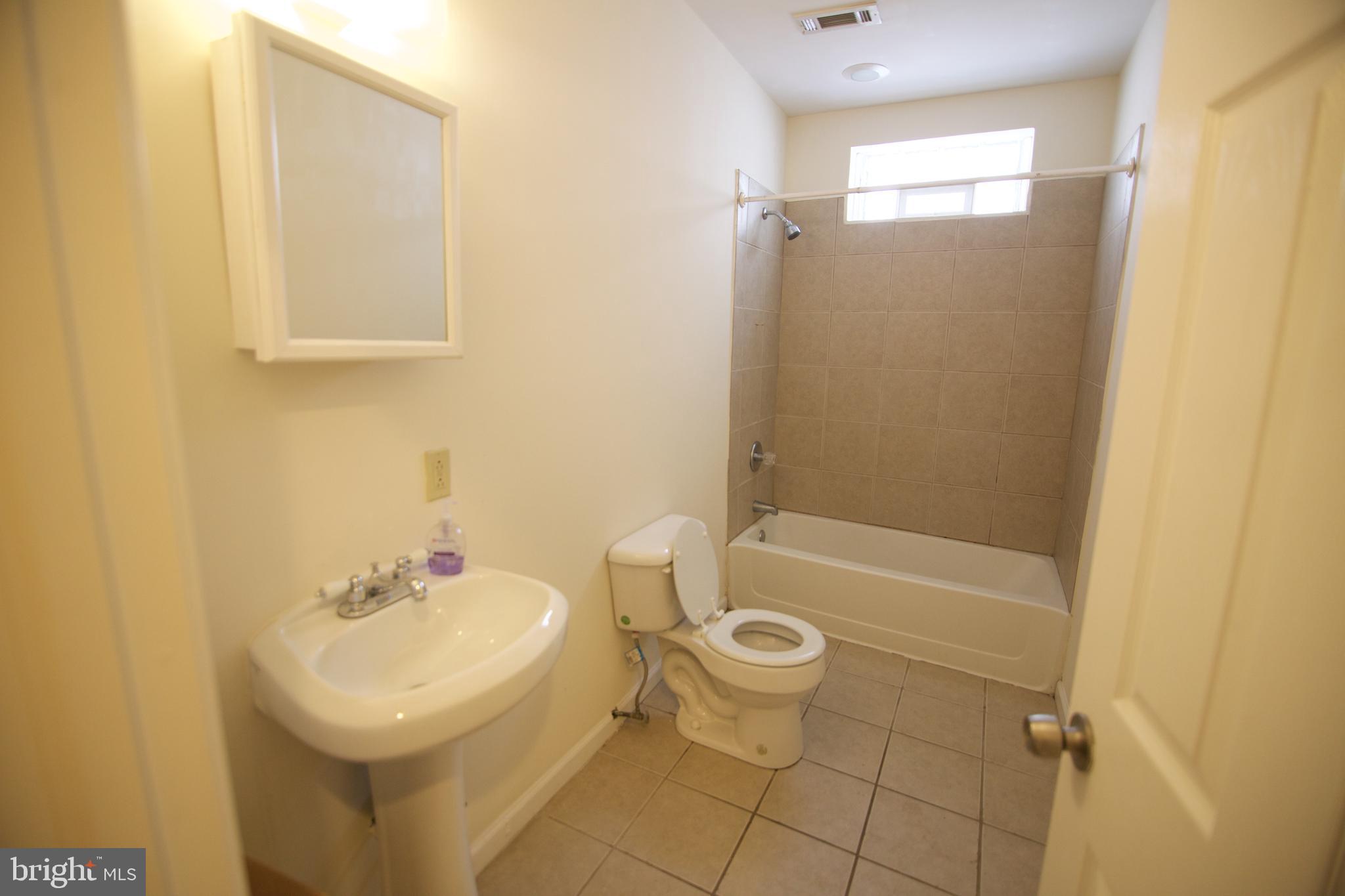 1522 North 17th Street, Unit 2 Philadelphia, PA 19121 - Photo 7 of 10 a bathroom with a sink a toilet and shower