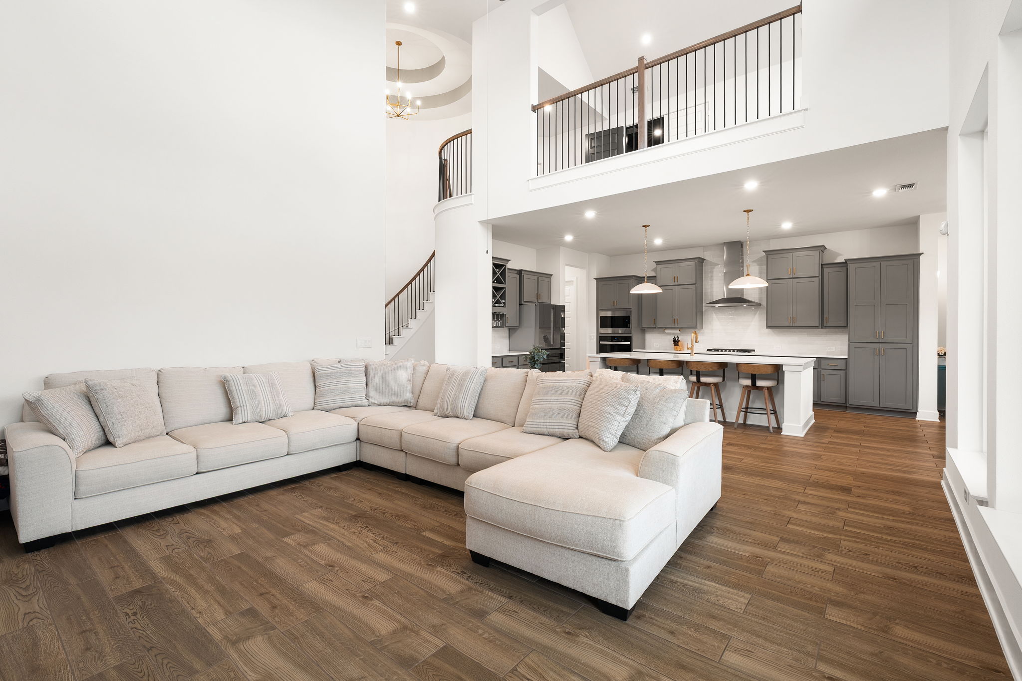 515 Watershield Cove Georgetown, TX 78633 - Photo 12 of 40 A spacious, open-concept interior unites living and culinary zones beneath soaring ceilings and an elegant upper-level balcony.