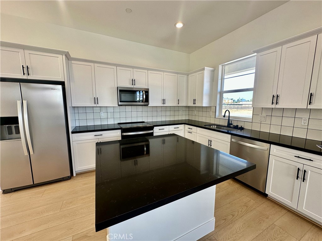 189 Cessna Court San Luis Obispo, CA 93401 - Photo 4 of 13 a kitchen with stainless steel appliances granite countertop a sink a stove a refrigerator a sink a microwave and cabinets