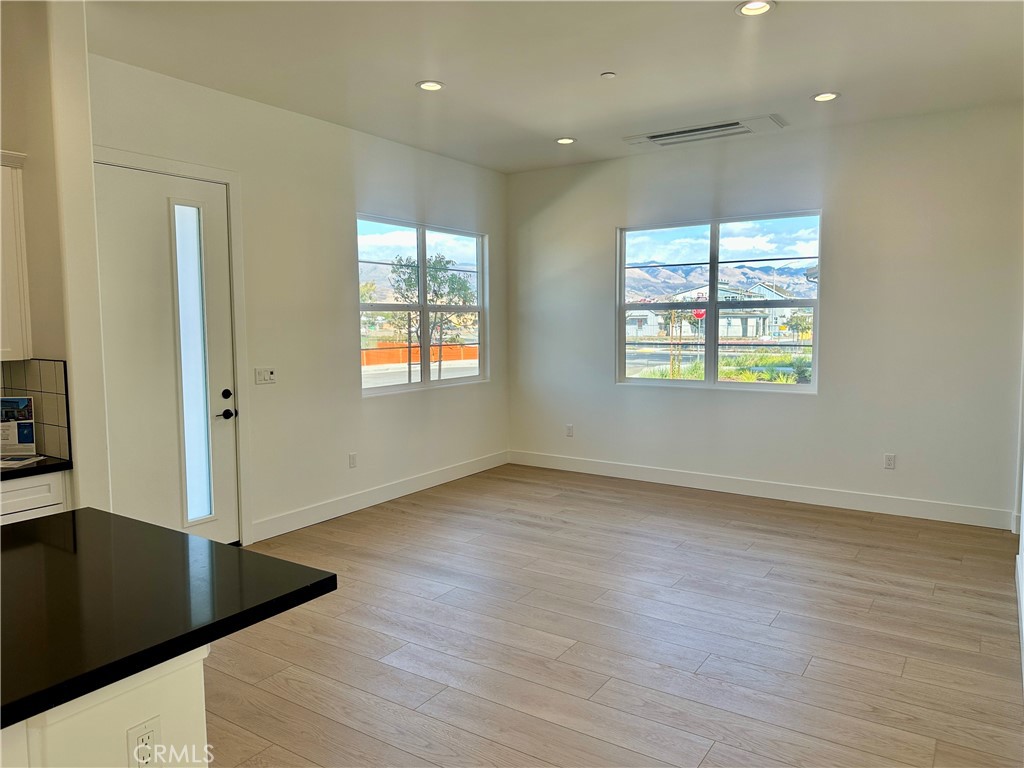 189 Cessna Court San Luis Obispo, CA 93401 - Photo 8 of 13 an empty room with wooden floor and windows