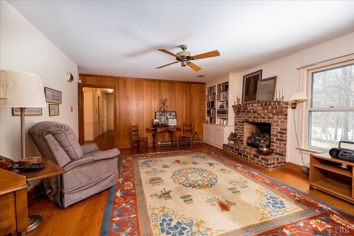 1086 Redfields Road Appomattox, VA 24522 - Photo 17 of 33 a living room with furniture bath tub and a fireplace