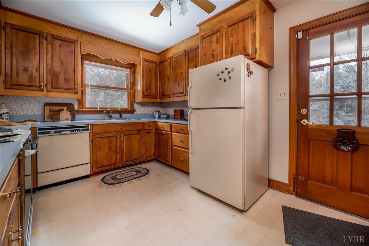 1086 Redfields Road Appomattox, VA 24522 - Photo 18 of 33 a kitchen with sink refrigerator and cabinets