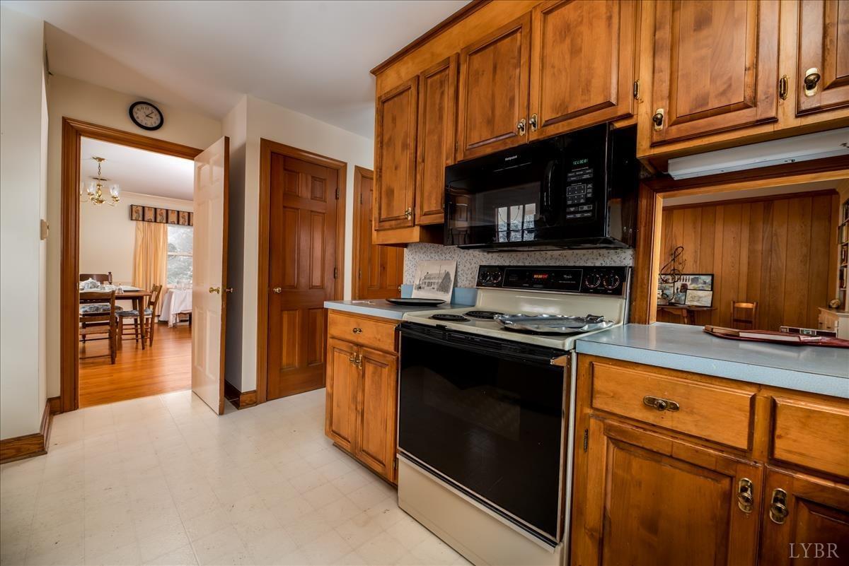 1086 Redfields Road Appomattox, VA 24522 - Photo 20 of 33 a kitchen with stainless steel appliances granite countertop a stove microwave and sink