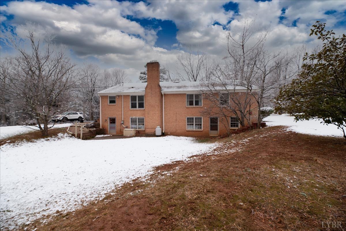 1086 Redfields Road Appomattox, VA 24522 - Photo 31 of 33 a front view of a house with a yard covered in snow