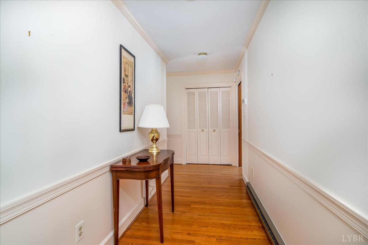 1086 Redfields Road Appomattox, VA 24522 - Photo 4 of 33 a view of a hallway with wooden floor and a table