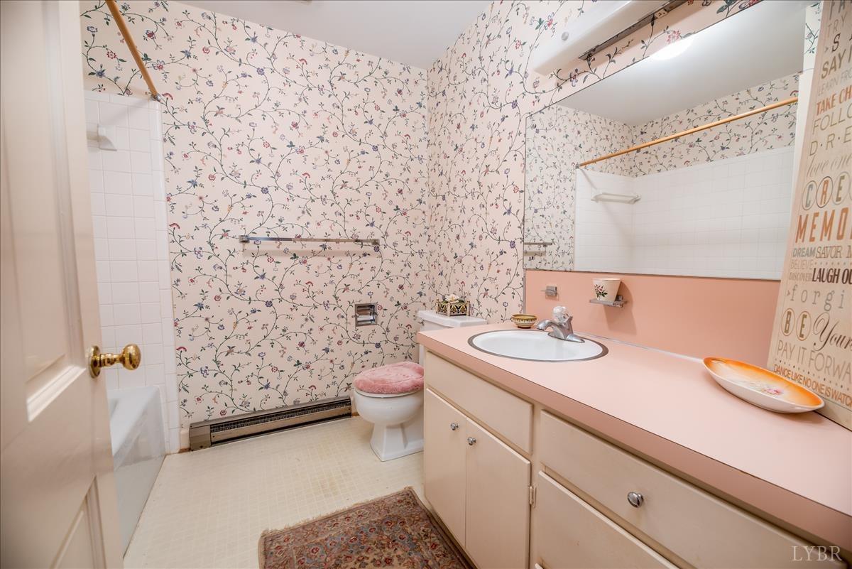 1086 Redfields Road Appomattox, VA 24522 - Photo 8 of 33 a bathroom with a granite countertop sink a toilet and a mirror
