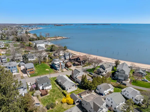 an aerial view of a city with lots of residential buildings and ocean view