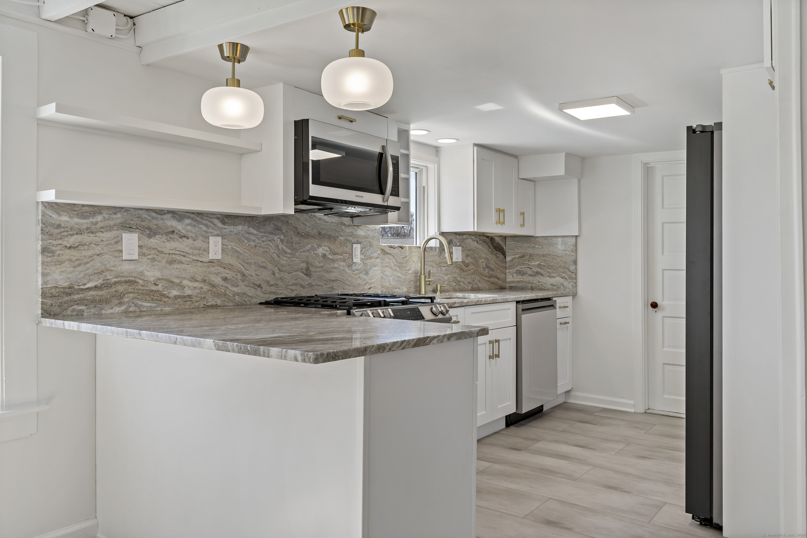 14 2nd Avenue Branford, CT 06405 - Photo 6 of 29 a kitchen with stainless steel appliances granite countertop a stove a sink and a microwave