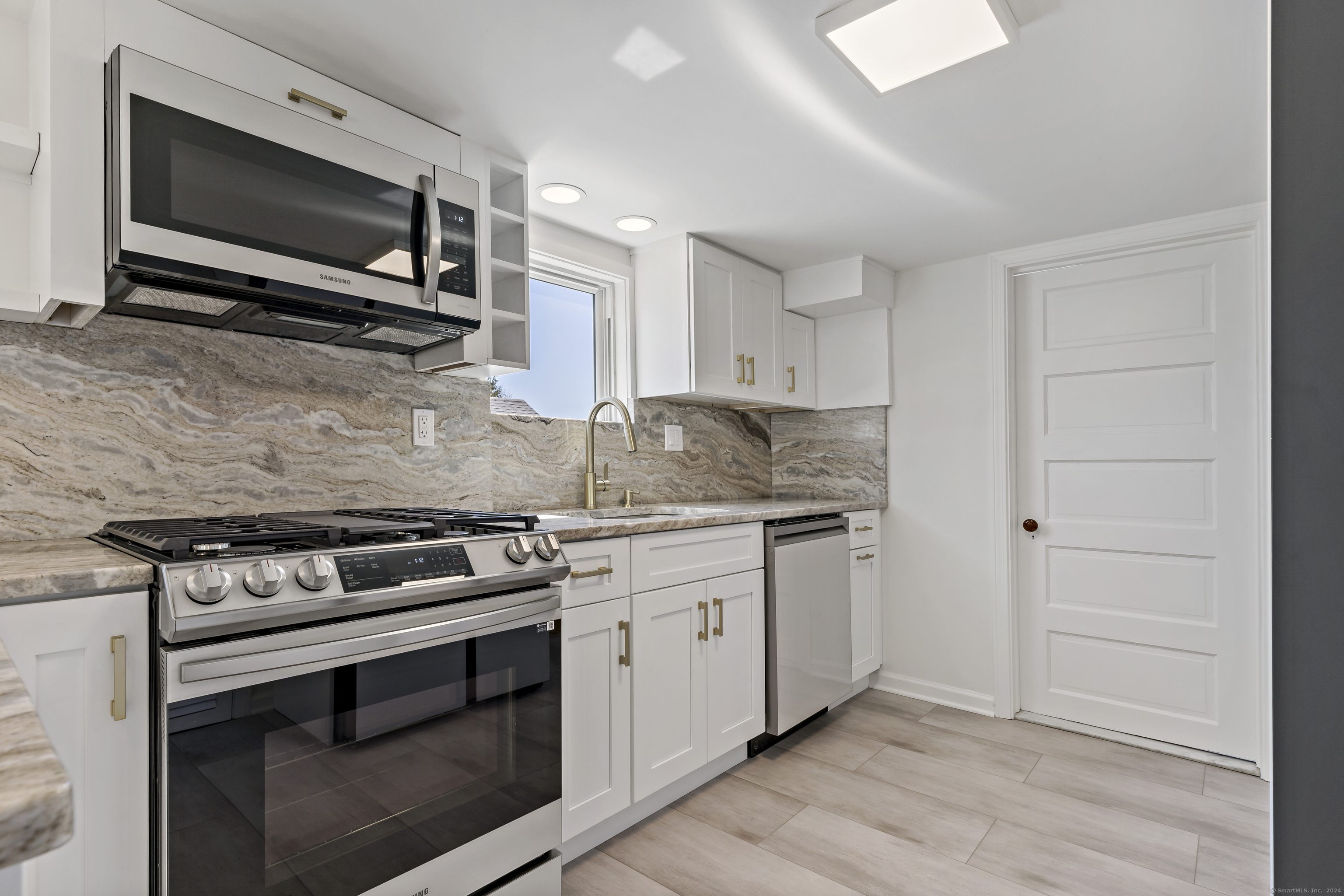 14 2nd Avenue Branford, CT 06405 - Photo 7 of 29 a kitchen with granite countertop a stove and a microwave
