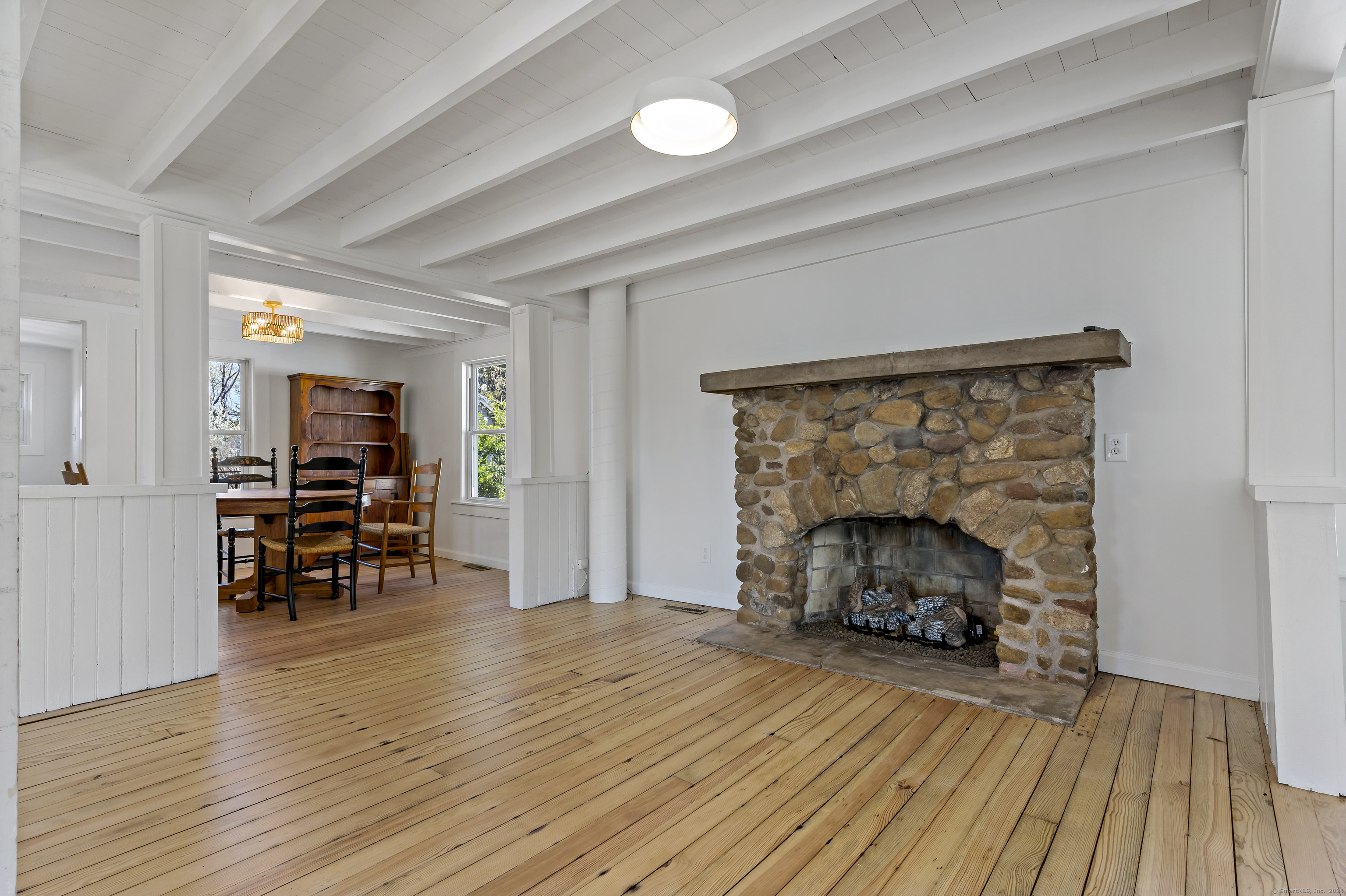 14 2nd Avenue Branford, CT 06405 - Photo 8 of 29 an empty room with wooden floor fireplace and furniture