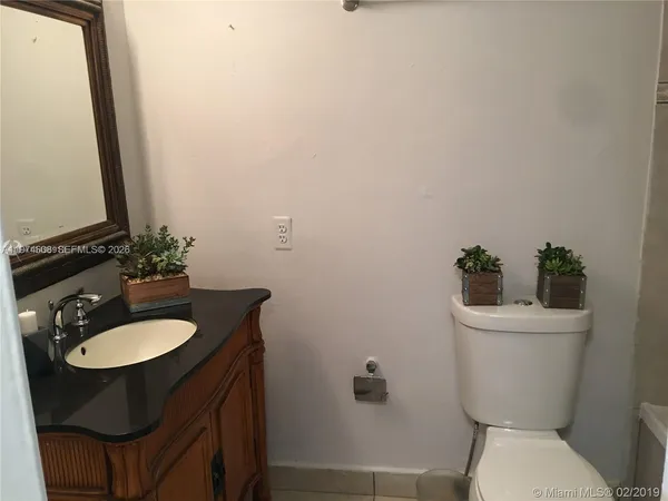 a bathroom with a sink toilet and a mirror