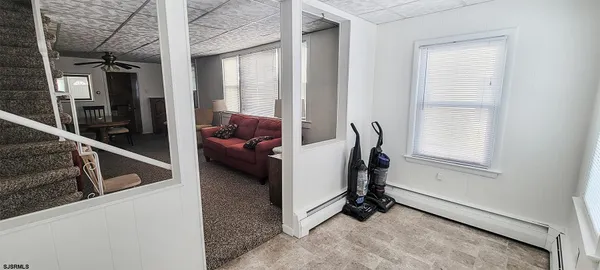 a living room with furniture a ceiling fan and a window