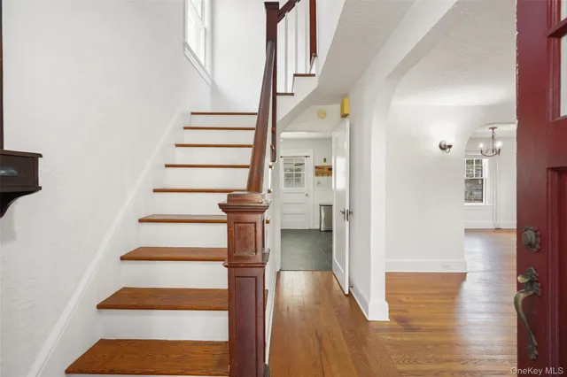a view of entryway and hall with wooden floor