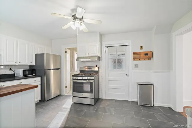 a kitchen with stainless steel appliances a refrigerator sink and cabinets
